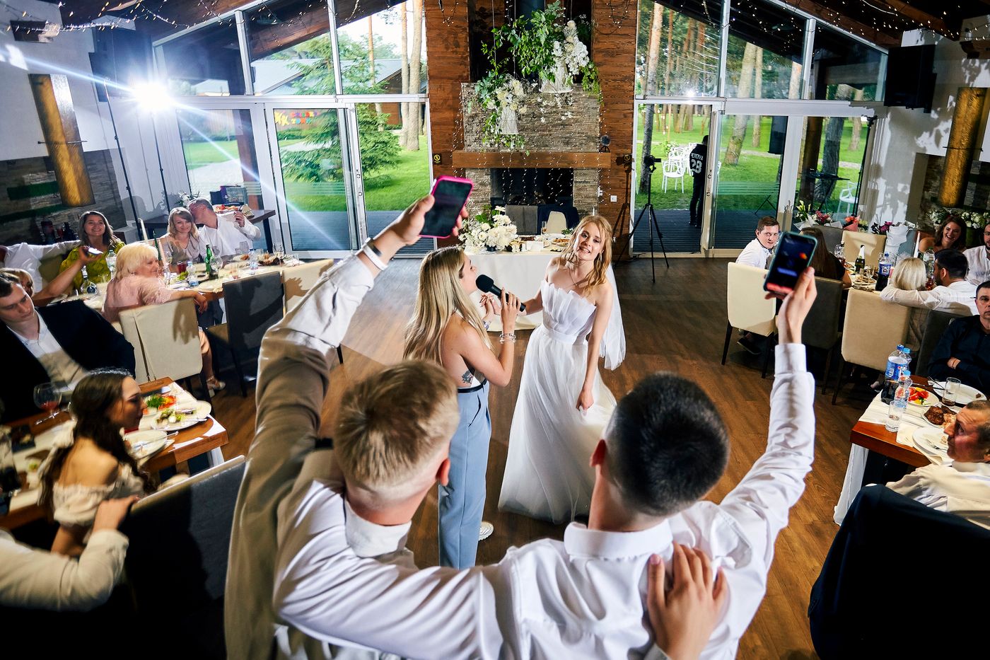 A singer entertaining a bride and guests at a real wedding reception